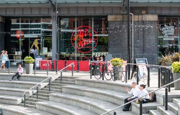A storefront with a red sign  at The Trilogy Apartments, Manchester, M15 4RU