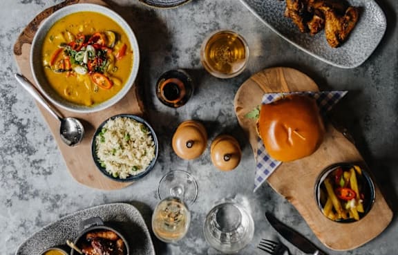 a table topped with different types of food and drinks at The Trilogy Apartments, Manchester, M15 4RU