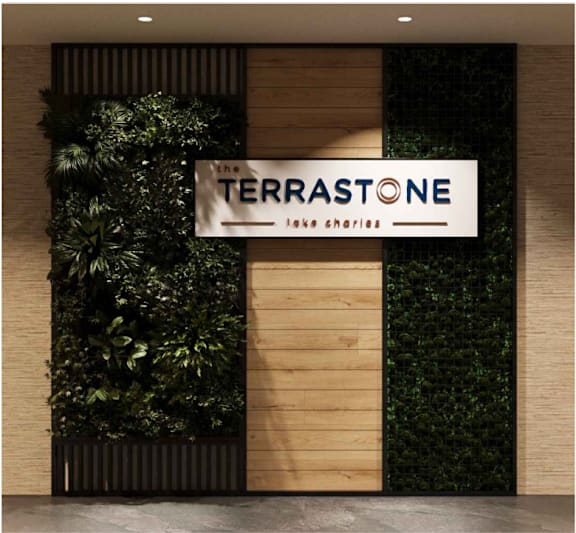 A sign that says "The Terrastone" is hanging on a wall.