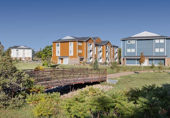 a bridge in front of a row of houses