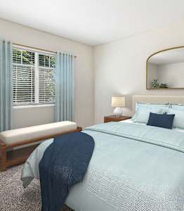 A bedroom with a bed, a bench, and a mirror.