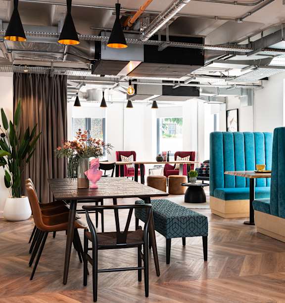 A modern dining area with a wooden table and chairs.