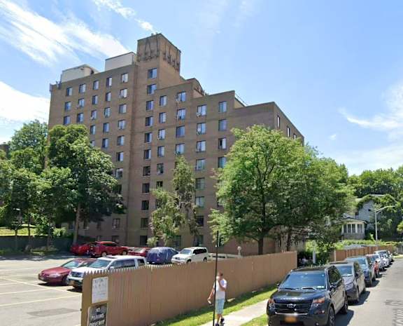 A large building with a parking lot in front of it.