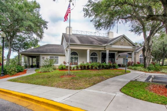 Walkway to Leasing Office with Flagpole  Shrubs and Decorative Trees
