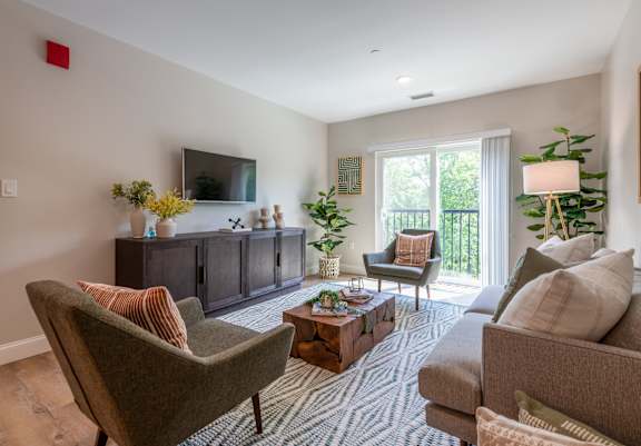 a living room with couches and chairs and a television at Edgebrook Residences, Merrimack, NH 03054