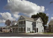 Thumbnail 4 of 6 - a rendering of an apartment building on the corner of a street