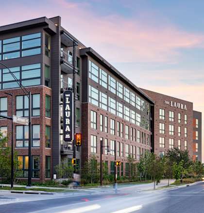 A street view of a building named The Laura.