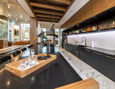 a large kitchen with black cabinets and marble counter tops at 19 South Apartments in Kissimmee, FL