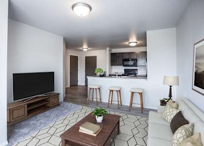 A living room with a television, a couch, and a coffee table.