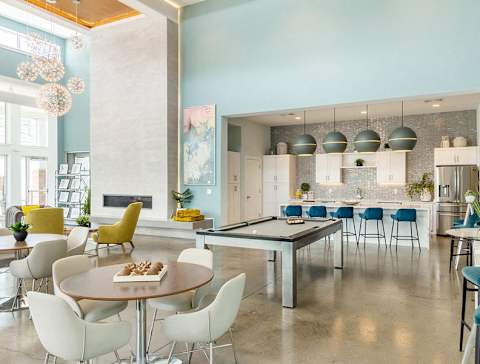 a living room with a ping pong table and a kitchen at Lumen Apartments, Virginia, 23666
