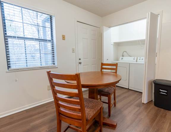 A room with a table and chairs and a window at Sandstone Court Apartments, Greenwood, IN.