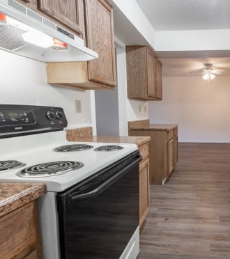 a kitchen with wood cabinets and white appliances and a white stove and refrigerator