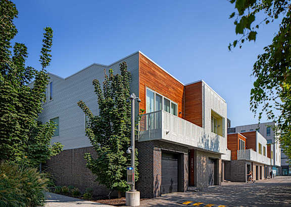 A modern building with a combination of white and wood panels.