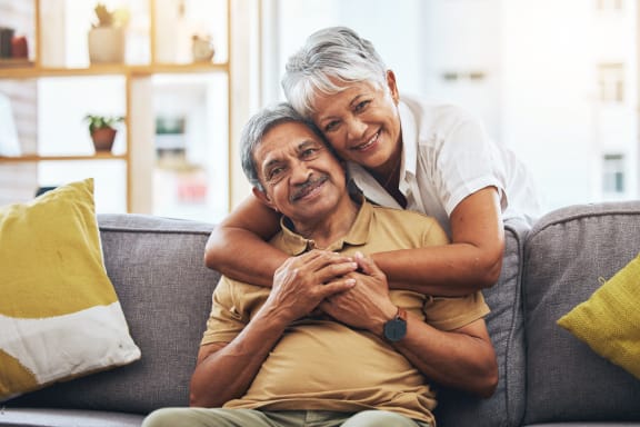 a woman hugging a man on a couch