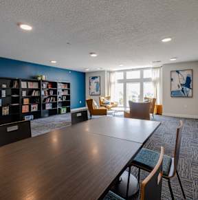 A room with wooden floors and white walls.at Hawthorne Pointe, Bondurant, IA