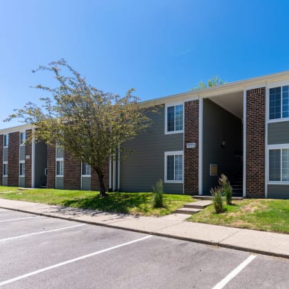 a gray building with a sidewalk in front of it