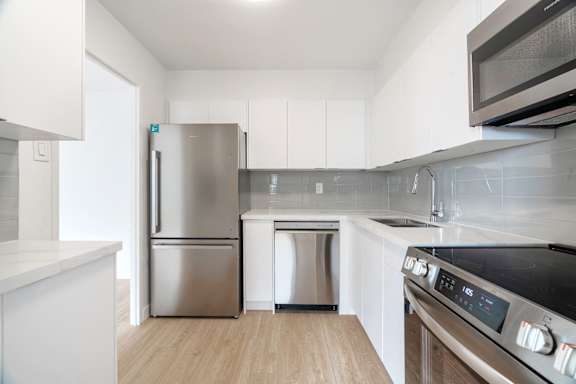 A modern kitchen with a stainless steel refrigerator and oven. at 70 Park, California, L5G 1M5