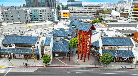 an aerial view of a city street with buildings with blue roofs