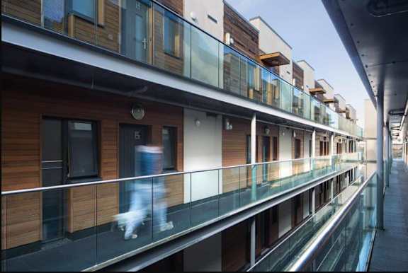 a person walking on a balcony of a building