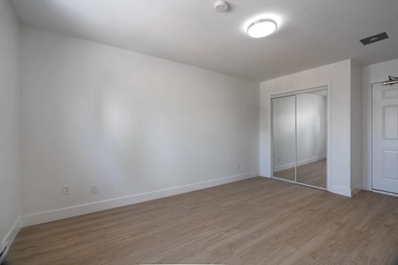 A room with a sliding glass door and wood flooring. at 608 Church Apartments, Toronto, ON, M4Y 2E7