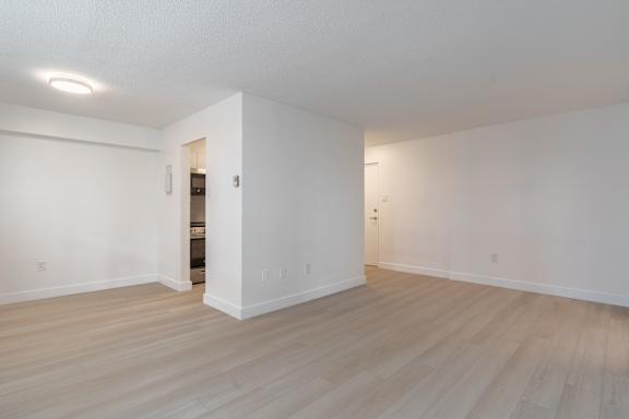 A room with white walls and wooden flooring with a doorway leading to another room. at 70 Park, Mississauga, CA, L5G 1M5