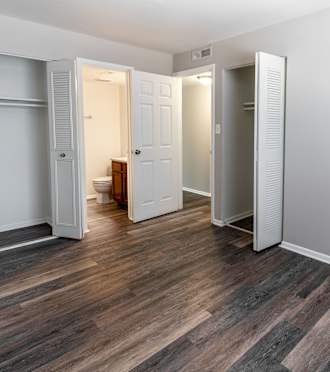 a kitchen with a black refrigerator and wooden cabinets at Pickwick Farms Apartments, Indianapolis, IN