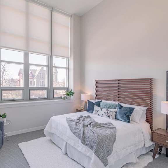 A bedroom with a large bed and a couch.