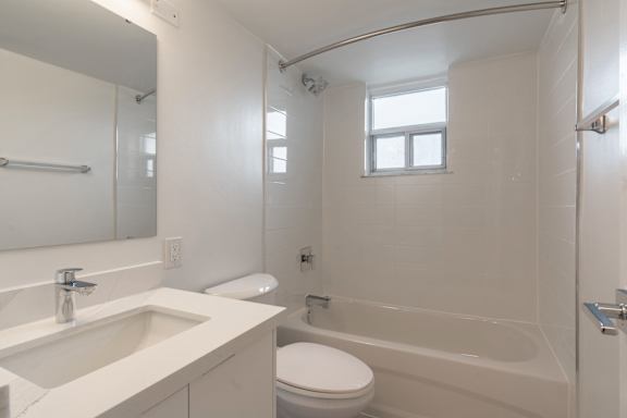 A white bathroom with a toilet, sink, and bathtub. at 70 Park, Mississauga, CA, L5G 1M5