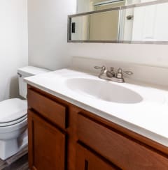 an empty bathroom with a toilet sink and mirror