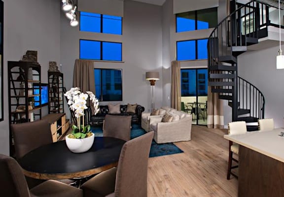 A modern kitchen with a dining table and chairs.