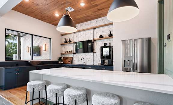 A kitchen with a white counter and bar stools. at DAWSON PARK Apartments , BATON ROUGE, 70809