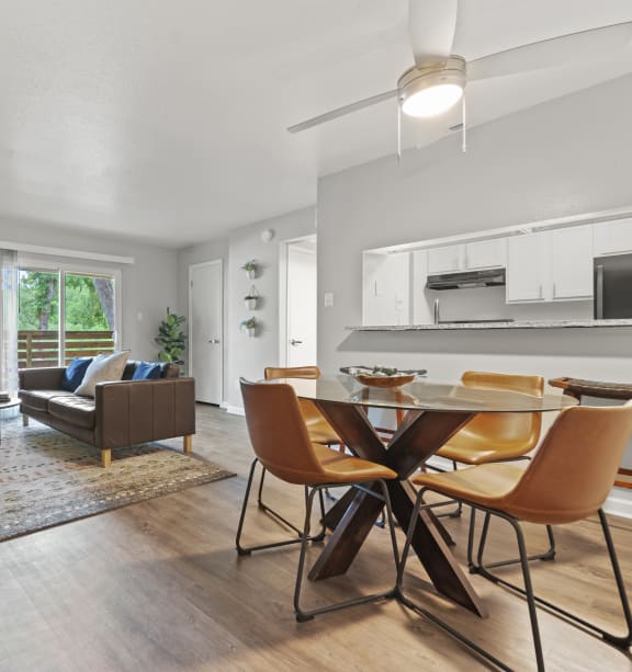 a large dining table with a view of the kitchen and living room