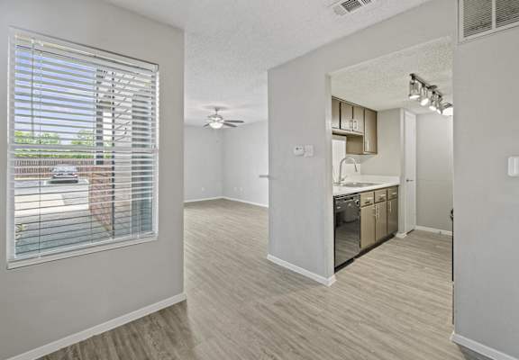 an open kitchen and living room with a large window