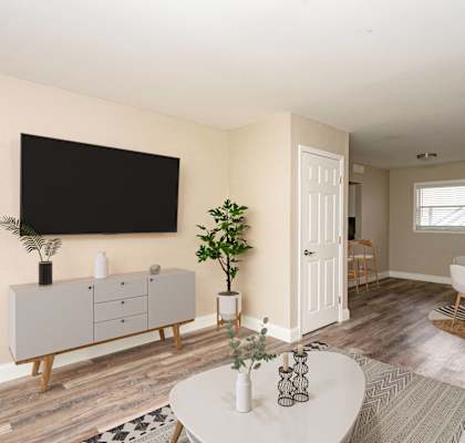 A living room with a white coffee table and a grey cabinet.