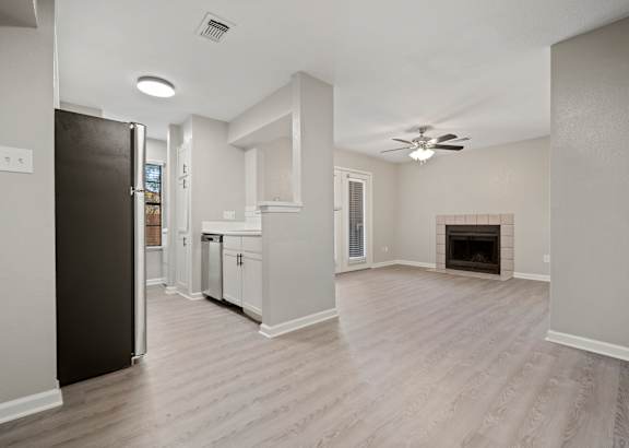 A spacious kitchen with white cabinets and a black refrigerator. at Polo Clubs Apartments, Austin, TX 78729