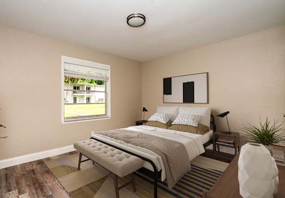 A bedroom with a large bed and a window.