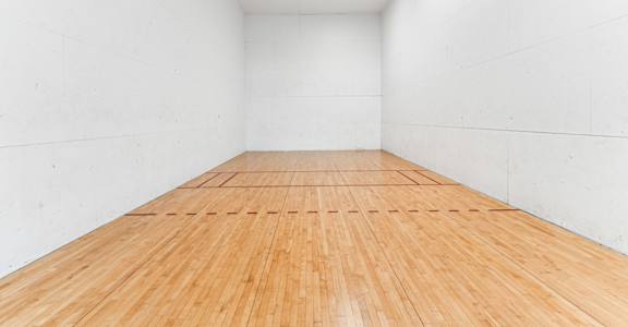 the indoor racquetball court is clean and ready to be used
