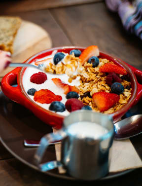 a bowl of cereal with milk and fruit at Melrose Villas, Phoenix, Arizona