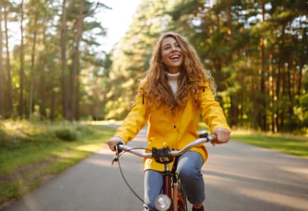 a young woman riding a bike down a road at The Walker Virginia Center in Glen Allen, Virginia