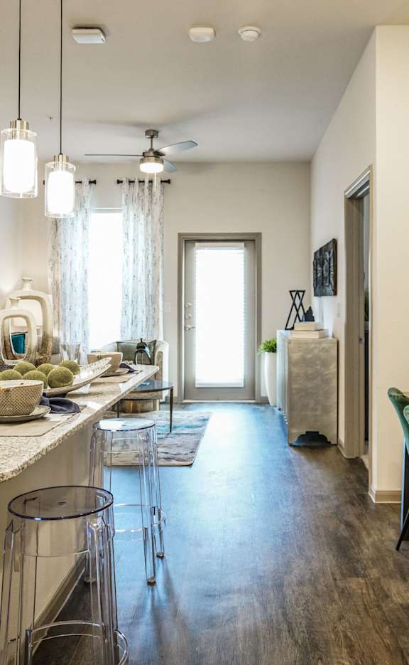 A kitchen with a dining table and chairs.
