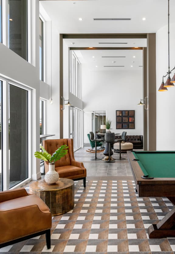 a living room with a pool table in the middle