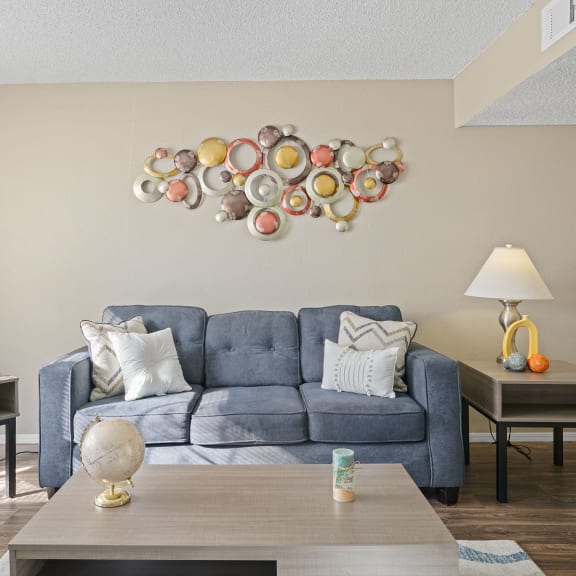 an open concept living room and dining area with a white dining table and rattan chairs