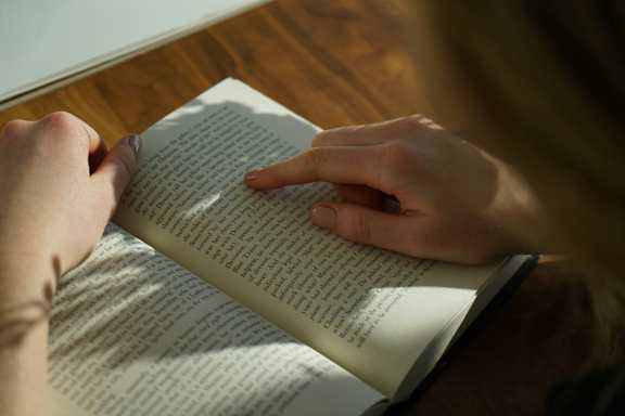 Someone Reading a Book in the Library