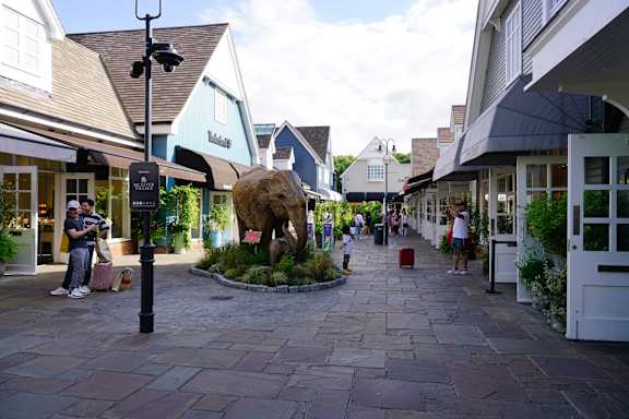 A stone statue of a bear is in the middle of a plaza. at The Woodlands Apartments, Milton Keynes, MK5 6GS