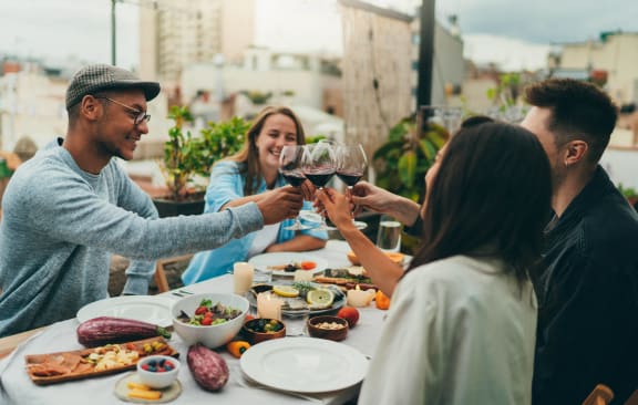 a group of people sitting around a table drinking wine at GrandView Flats and Townhomes, Granger