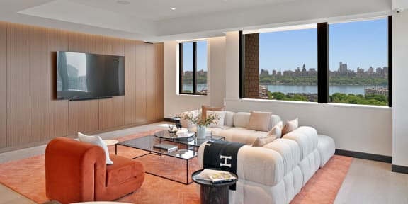 a cityscape with a river in the background and a large building in the foreground  at Riello Apartments Owner LLC, New Jersey