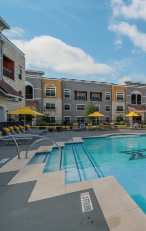 a large pool in front of a brick building