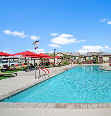 A large swimming pool with a red pool ladder.