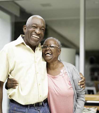 a man and a woman standing together and laughing at Mariposa at South Broadway, Texas