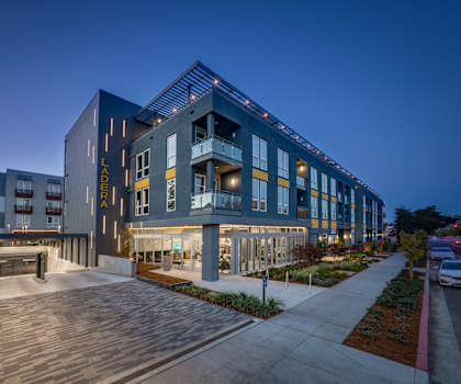 a large building with a sidewalk and walkway in front of it